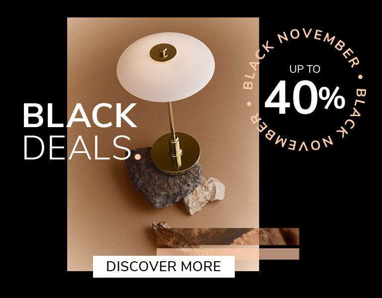 Elegant designer table lamp on natural stone base with gold stem and white shade, promoting Black November sale – up to 40% off with text ‘First Black Deals’ and ‘Discover More’ button.